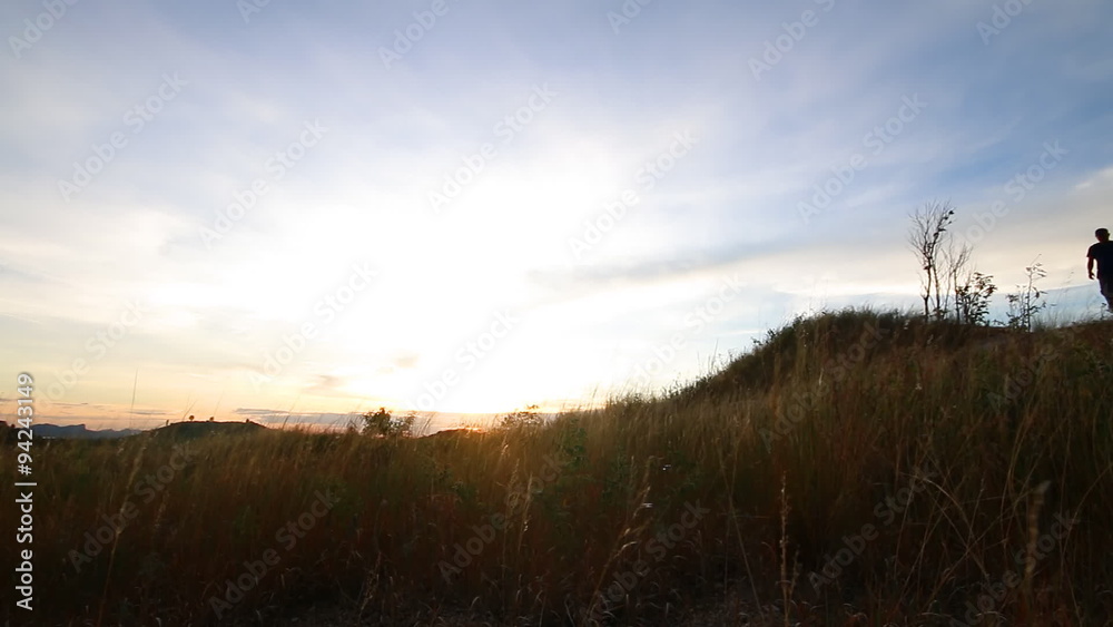 Traveler walking alone on the mountain with blue sky Traveler walking alone on the mountain with blue sky