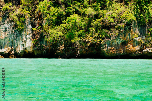 Green sea water infront of green island © TinPong