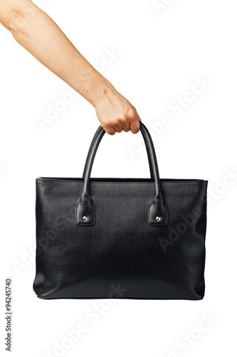 hand holding women's leather handbag