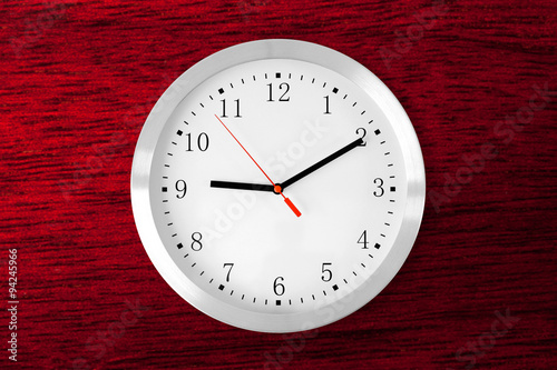 classic clock on red wood mahogany background
