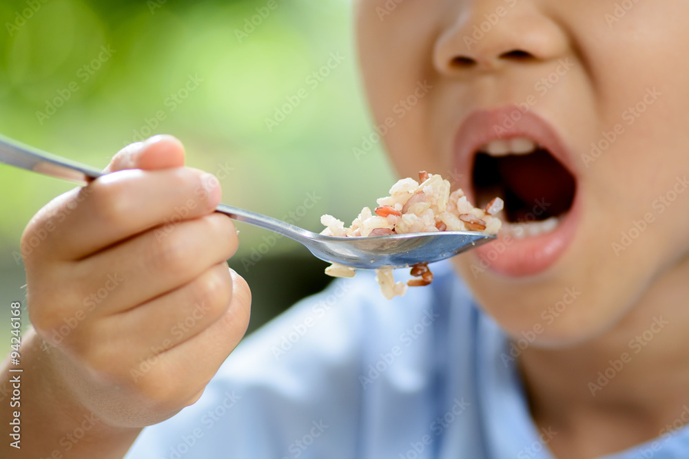 Boy eat Thai rice.