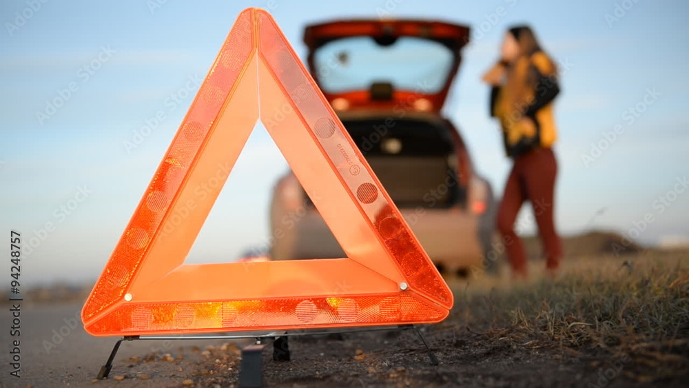 Young woman with a triangle which has broken down
Warning triangle close-up 