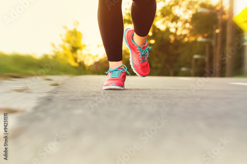 Woman runner jogging down an outdoor path