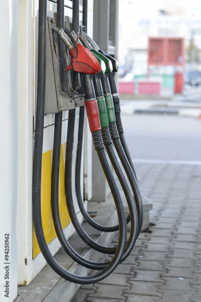 Fuel nozzles at a gas station.