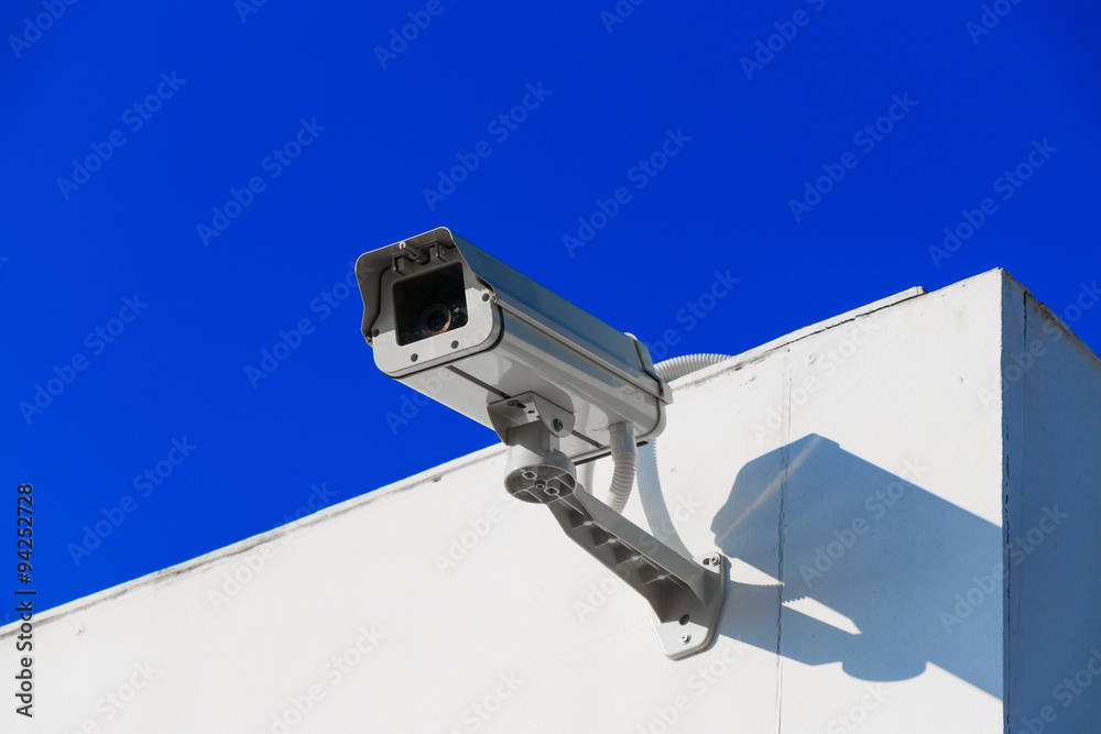 CCTV on building with blue-sky background CCTV on building with blue-sky background