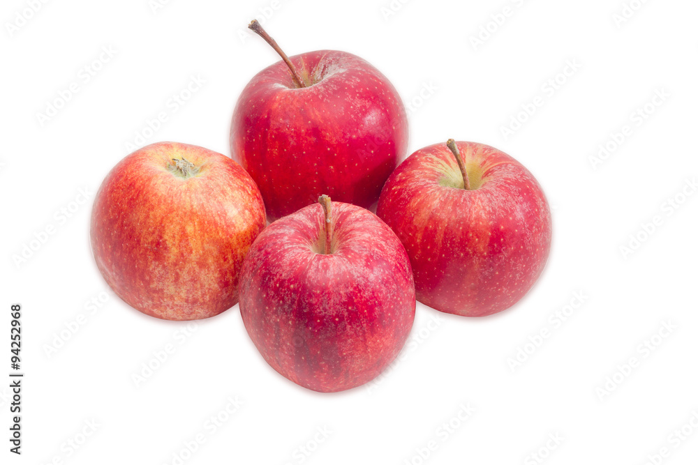 Four red apples on a light background