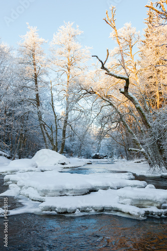 Ice floes and snow in the river in the winter forest