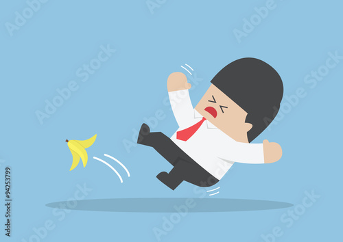 Businessman slipping on a banana peel