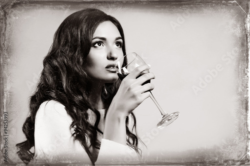 Portrait of beautiful woman drinking wine, black and white retro stylization