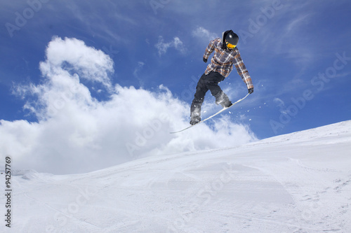 Flying snowboarder on mountains