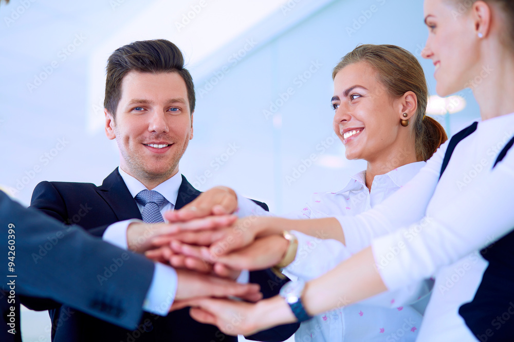 Business people with their hands together in a circle Business people with their hands together in a circle