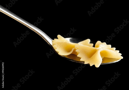 raw pasta in spoon closeup