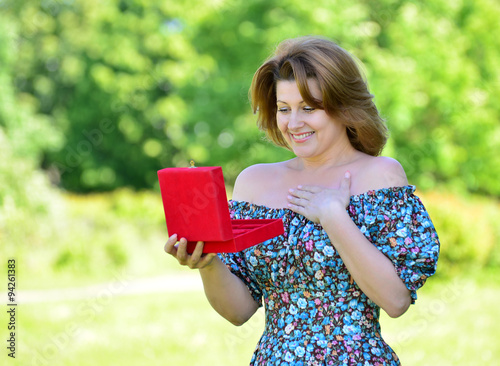 Cute woman with gift at summer park