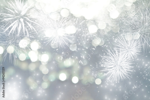 Abstract holiday background with fireworks and sparkling lights