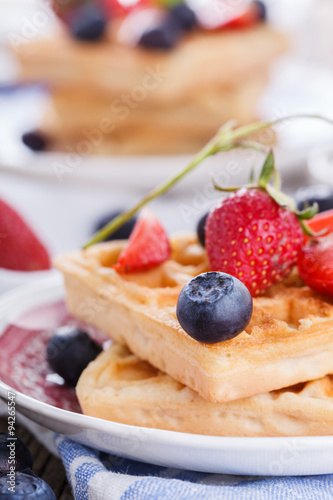 Waffles with strawberries and blueberries for Breakfast,Belgian.selective focus