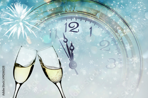 Champagne over fireworks and clock close to midnight
