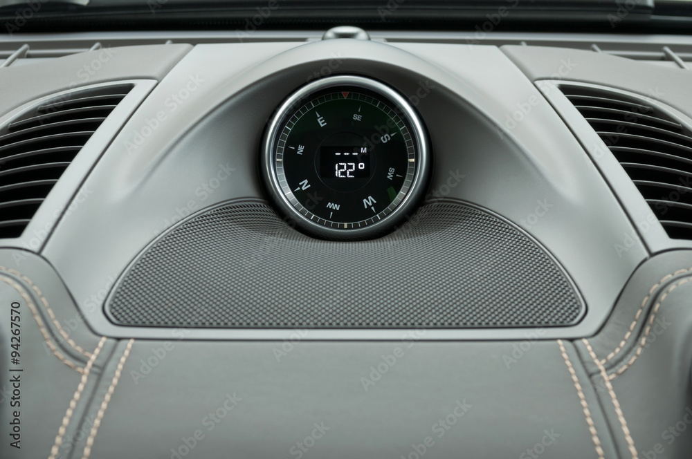 Modern car dashboard compass. Interior detail.