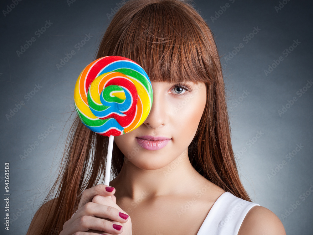 portrait of redhead woman with big lollipop