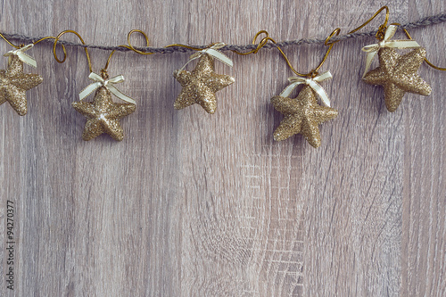 Christmas decorations hanging over wooden background