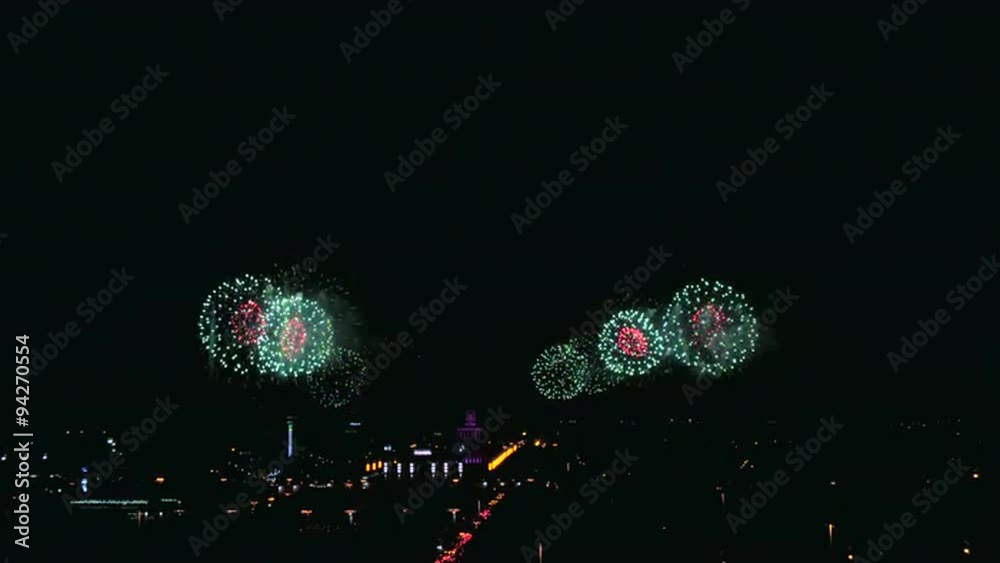 A beautiful fireworks in the big city in the night sky and buildings. 