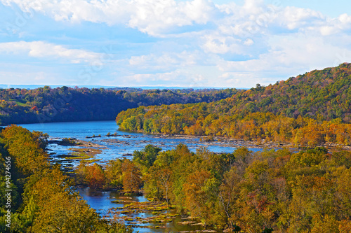 View on Shenandoah River and Blue Ridge mountains from Harpers Ferry overlook. Blue river and autumn trees foliage on a bright afternoon, West Virginia, USA.