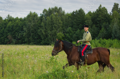 Russian Cossack inspecting the border on horseback © Demian