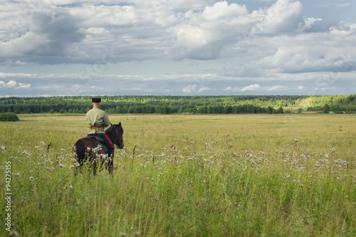 Russian Cossack inspecting the border on horseback © Demian