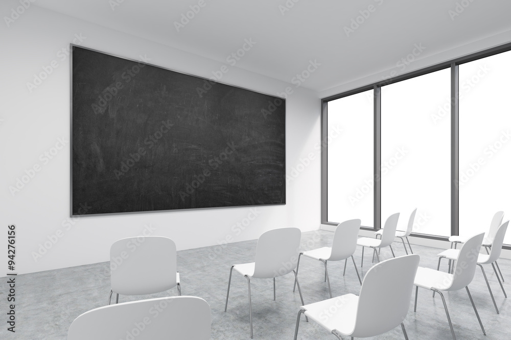 A classroom or presentation room in a modern university or fancy office. White chairs, panoramic windows with white copy space and a black chalkboard on the wall. 3D rendering. A classroom or presentation room in a modern university or fancy office. White chairs, panoramic windows with white copy space and a black chalkboard on the wall. 3D rendering.