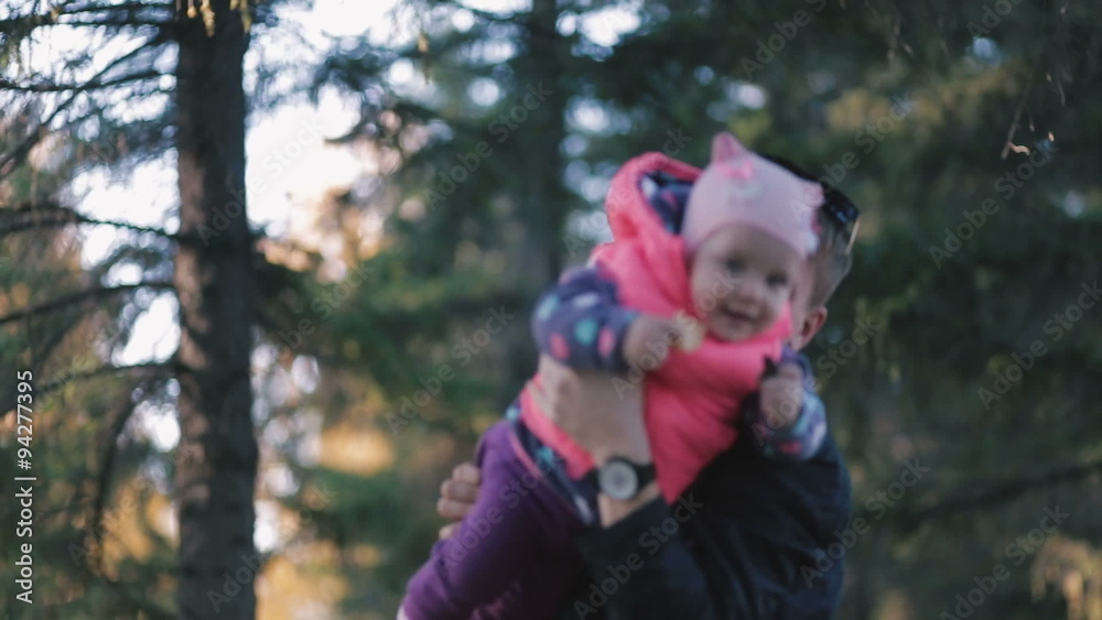 Funny father turns her daughter in her arms. Funny father turns her daughter in her arms.