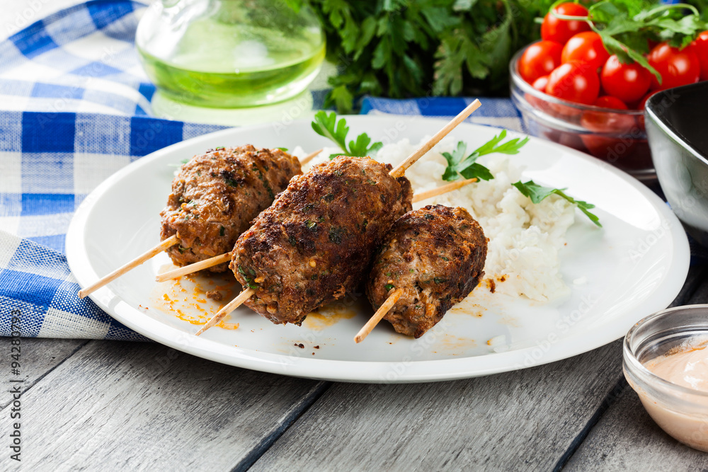 Barbecued kofta with rice on a plate