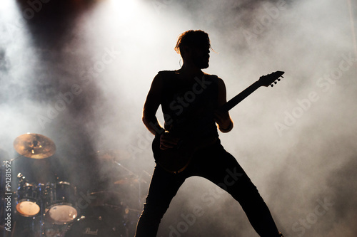 фотографія silhouette of a a guitarist on stage