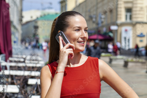 Happy beautiful women calling by phone