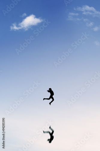 Joyful businesswoman leaps on the clear sky