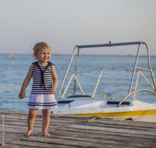 Portrait of a child with golubymi eyes on the pier at the boat photo