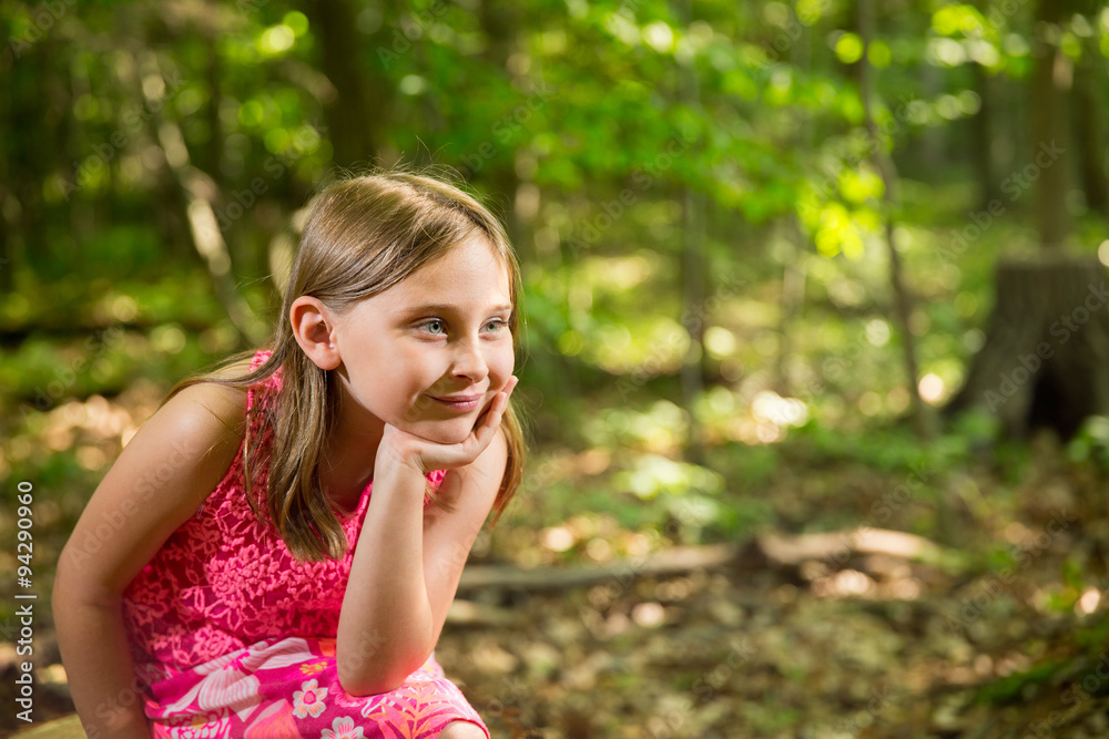 Happy Young Girl Sitting in Woods Looking at Copy Space Happy Young Girl Sitting in Woods Looking at Copy Space