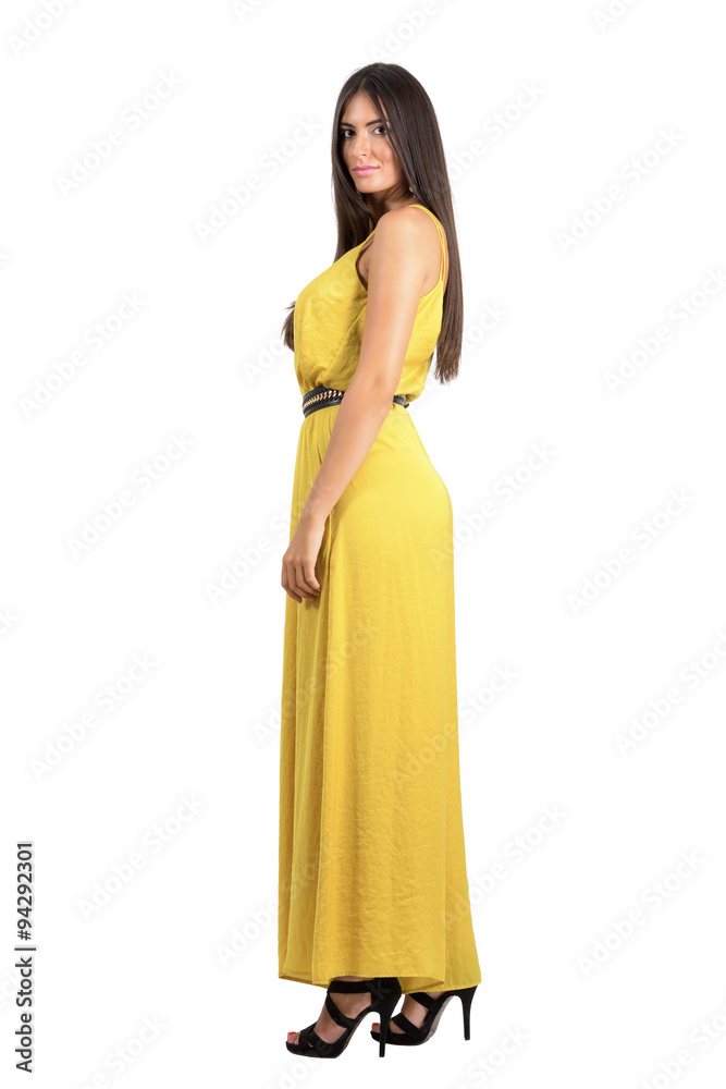 Elegant beauty model in yellow evening dress side view isolated Elegant beauty model in yellow evening dress side view isolated