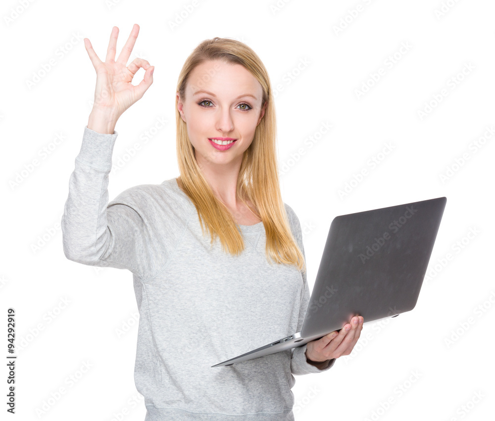 Woman hold with notebook computer and ok sign gesture Woman hold with notebook computer and ok sign gesture