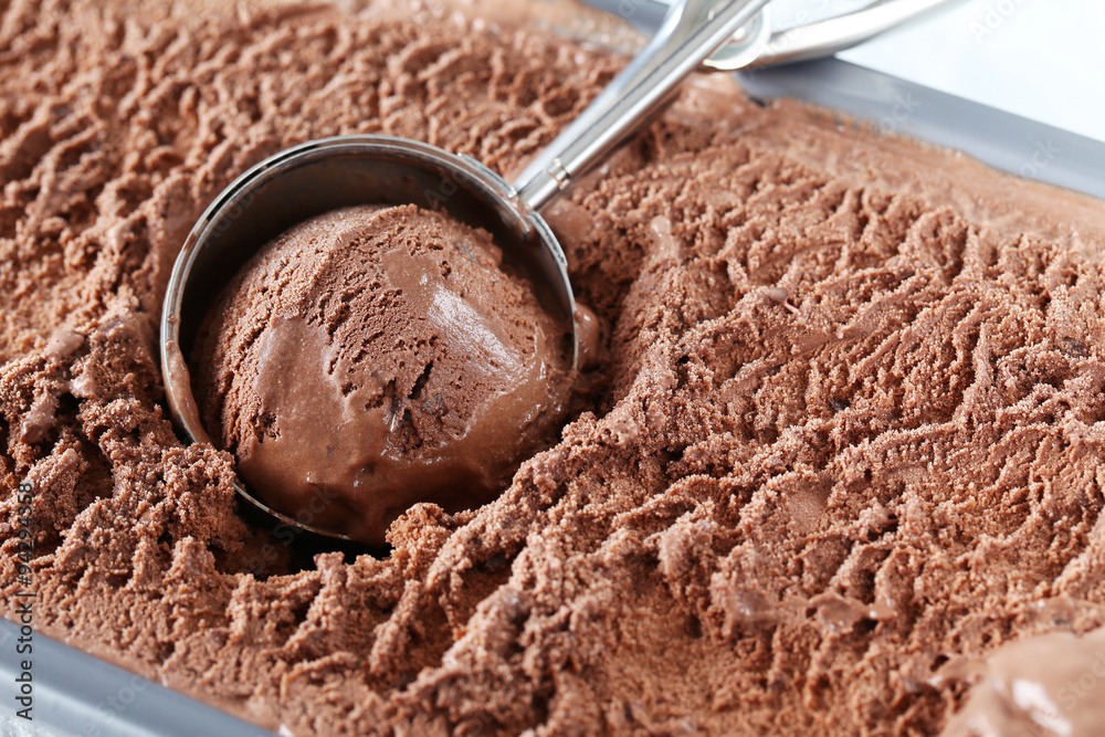 Chocolate ice cream scooped out from container Chocolate ice cream scooped out from container