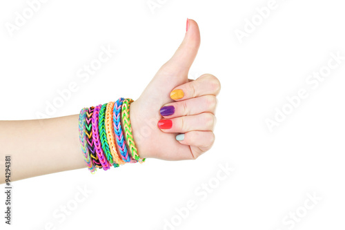 Loom bracelets on hand of young girl, showing thumbs up
