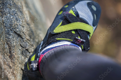 Rock climber taking selfie of his foot when climbing her route