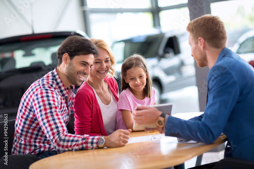 Young family  in car dealership