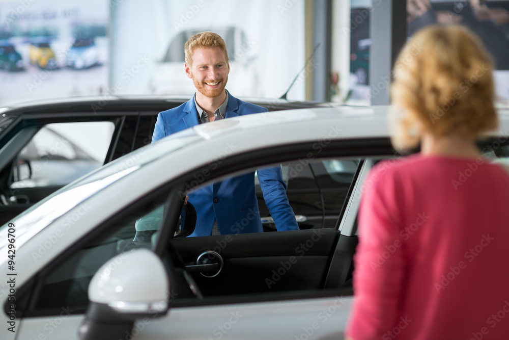 sales manager at a showroom car with costumer sales manager at a showroom car with costumer