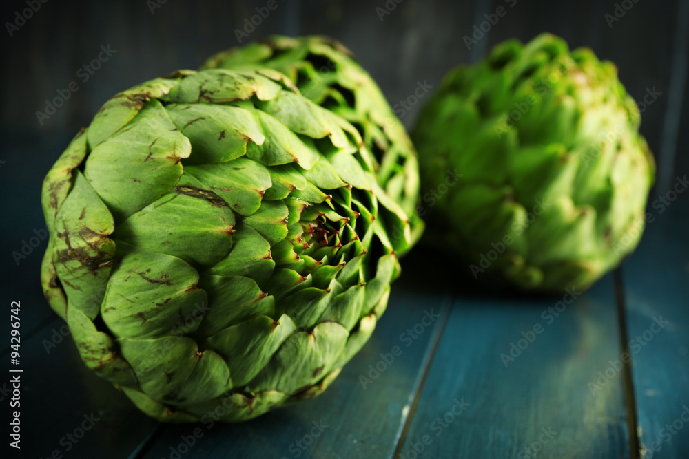Artichokes on color wooden background Artichokes on color wooden background