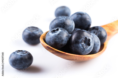 Fresh blueberries in wooden spoon