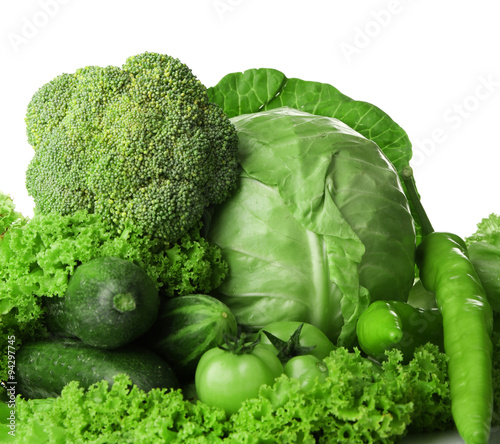 Heap of green vegetables isolated on white
