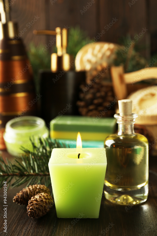 Essential oil of pine, handmade soap and cream with pine extract and spa treatments on wooden background Essential oil of pine, handmade soap and cream with pine extract and spa treatments on wooden background