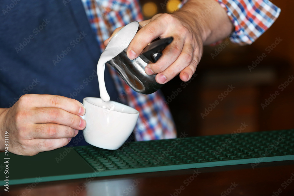 Bartender making white coffee at bar