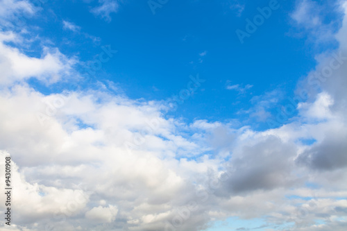 low gray and white clouds in blue sky