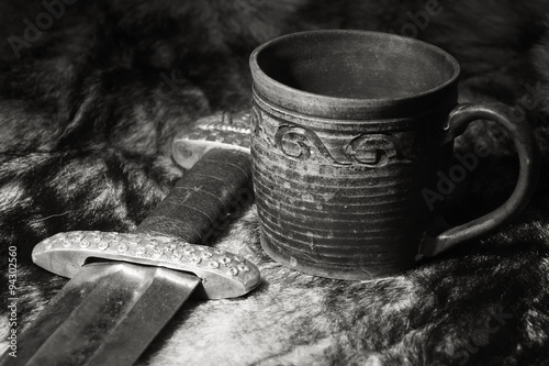 Viking sword and stein on a fur photo