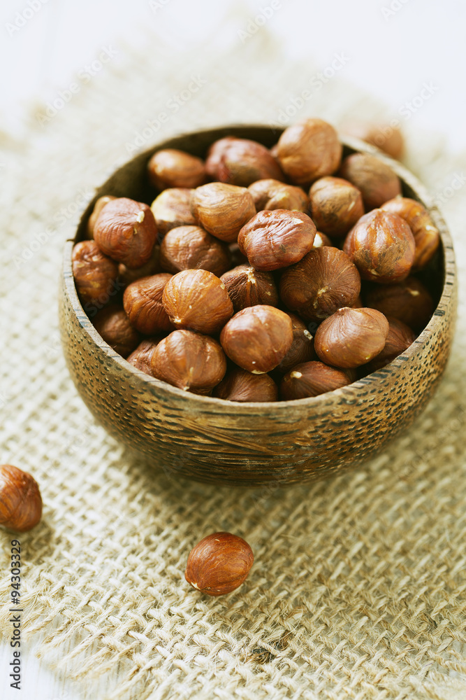 hazelnuts in a wooden bowl hazelnuts in a wooden bowl